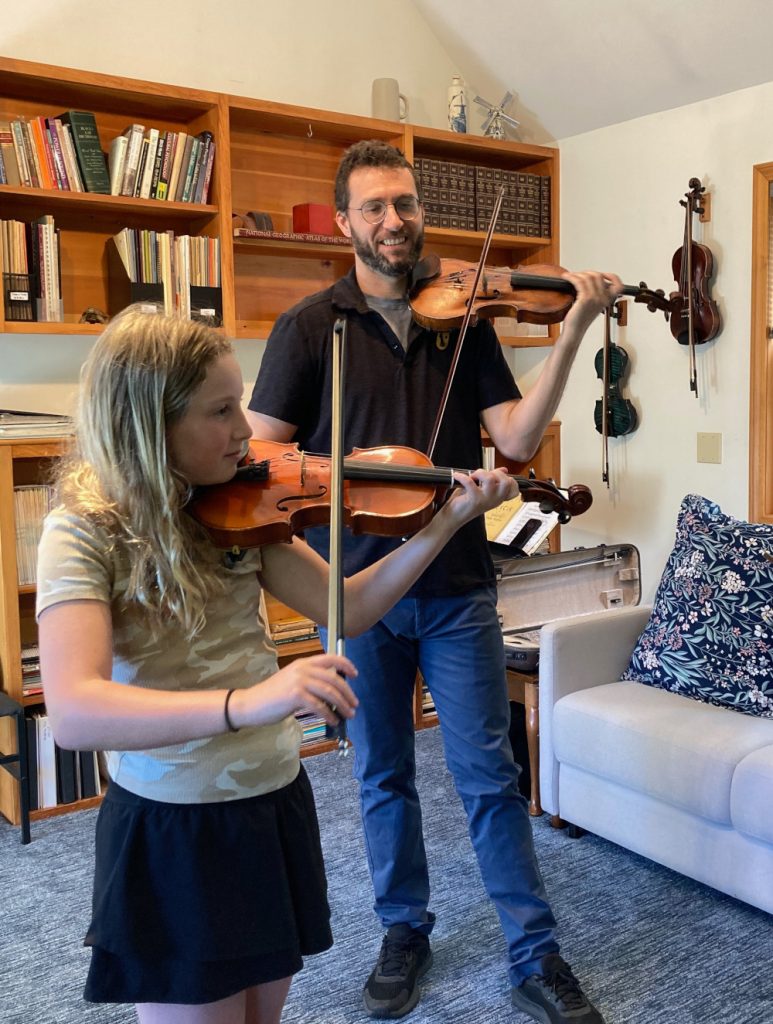 Shelby teaches a pupil in a violin lesson